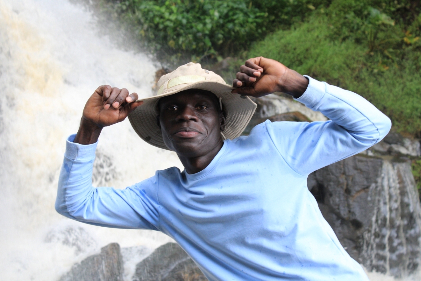 A young African man posing for a photo.