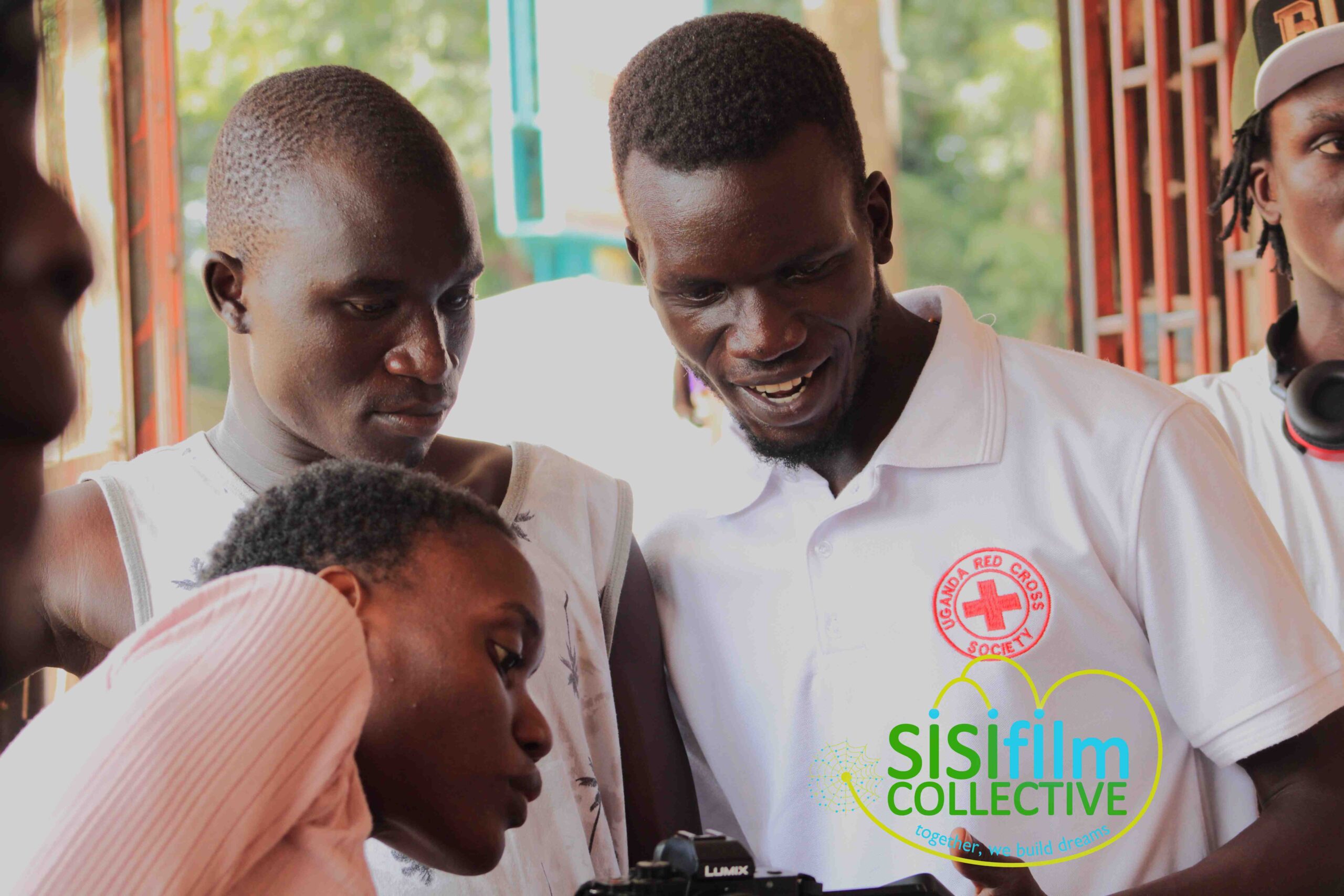 A group of young adults engaging in a camera class