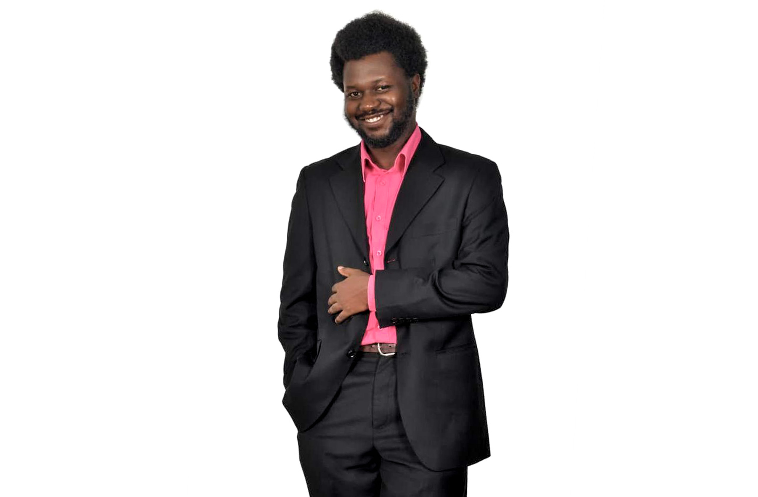 A man posing for a photo in a suit.